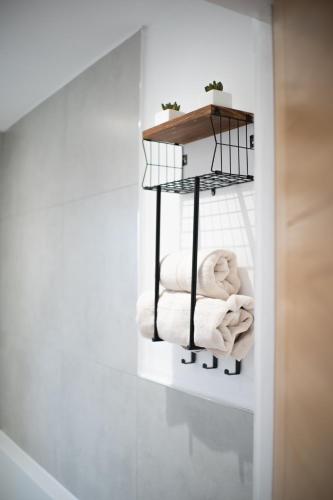 a bathroom with a towel rack with towels at New Reno l Bright l Heart of the City l SelfCheckin in Hatfield