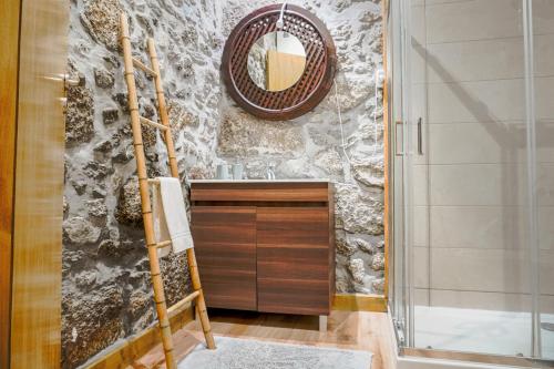a bathroom with a sink and a mirror at Casas de Fralães in Grimancelos