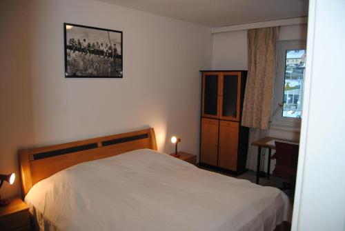 a bedroom with a white bed and a window at Fewo Ossiach in Ossiach