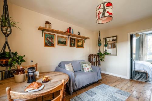 a living room with a table and a couch at Lakeview in London