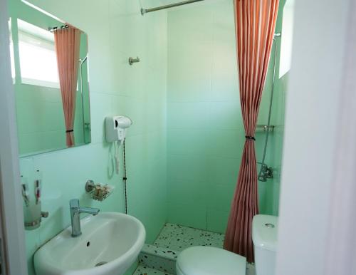 a bathroom with a sink and a shower at Hotel Maisis Ezo in Kutaisi