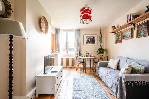 a living room with a couch and a table at Lakeview in London