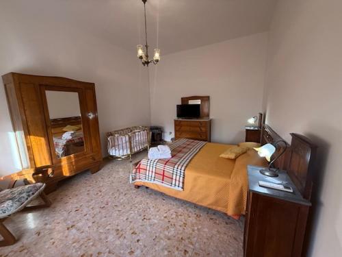 a bedroom with a bed and a dresser and a mirror at Casa Vacanze Nonna Mena in Fontechiari