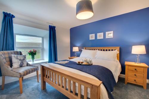a blue bedroom with a bed and a chair at 5 Bed in Fryup Dale oc-wa291 in Danby