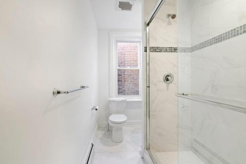 a white bathroom with a toilet and a shower at Candlelight Chamber - Private Room with Shared Space in Chester