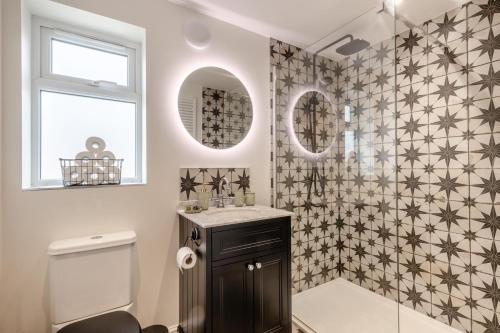 a bathroom with a shower and a sink and a toilet at 2 Bed in Aylsham oc-s30931 in Aylsham