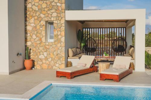 a patio with a swimming pool and a house at Aiolia Villa in Lachania