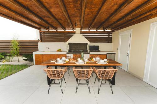 a kitchen and dining room with a wooden table and chairs at Aiolia Villa in Lachania