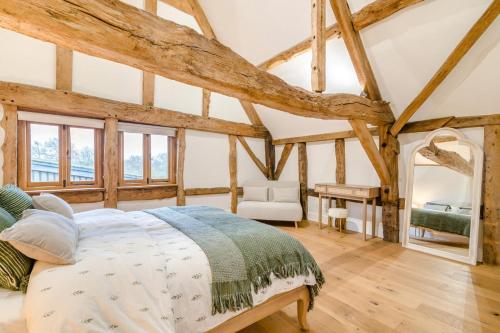 a bedroom with a large bed in a room with wooden beams at 4 Bed in Etloe oc-e34026 in Awre