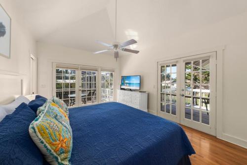 a bedroom with a blue bed and a ceiling fan at Lighthouse Lookout in Sanibel