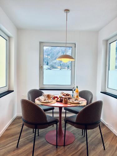 a dining room with a table and chairs and a window at LYMA Suites - Apartment B44 in Immenstadt im Allgäu