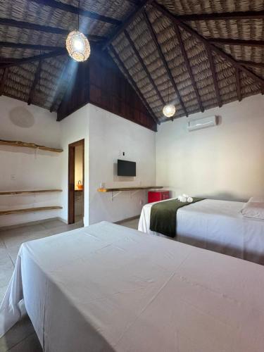 a hotel room with two beds and a tv at POUSADA AMORIM in Santo Amaro