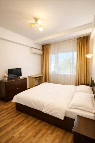 a bedroom with a large bed and a window at Warm Place In Old Town in Bucharest