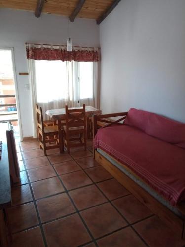 a bedroom with a bed and a table and chairs at Cabañas Dolce Far Niente in Tandil