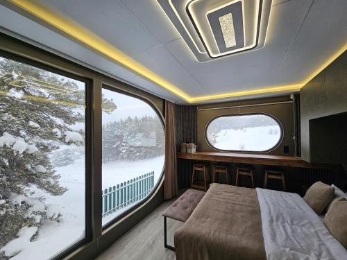 a bedroom with a bed and a window in a train at Econest Aparan in Aparan