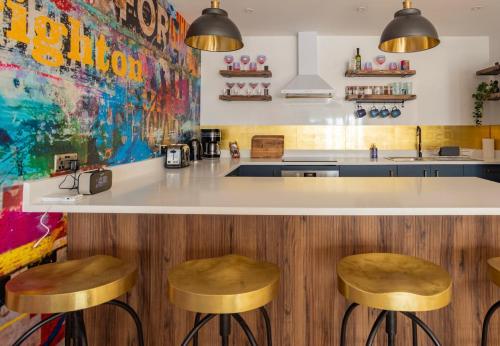 a kitchen with a counter and two stools at Mrs Butlers Stylish Mews House Central Brighton Great Prices in Brighton & Hove