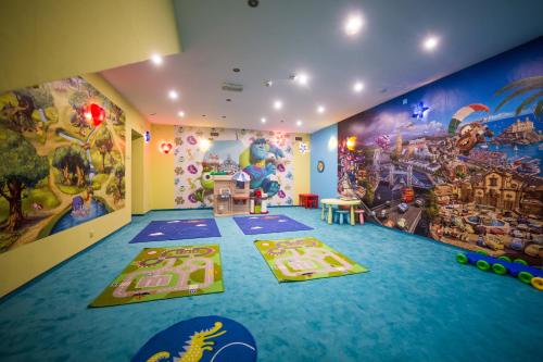 a room with a large mural on the wall at Leśne Patio in Katowice