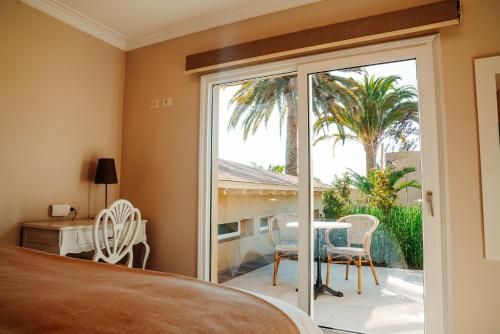 a bedroom with a sliding glass door leading to a patio at Hacienda Huamalata in Ovalle
