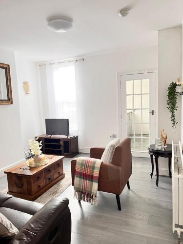 a living room with a couch and a coffee table at Feel at Home away from Home in Nottingham