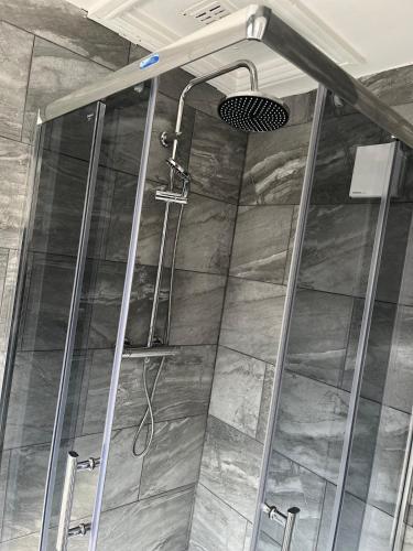 a shower with a glass door in a bathroom at Feel at Home away from Home in Nottingham