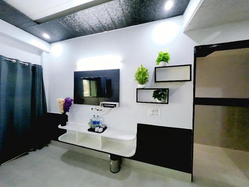 a bathroom with a white sink and a mirror at Evesta Micasa in Haridwār