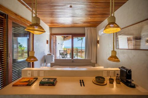 a room with a bedroom with a bed and a table at Casa Siará - Hotel & Vilas in Prea