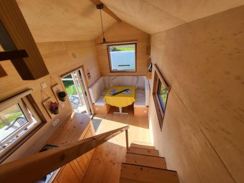 an overhead view of a tiny house with a yellow table at maison du bonheur in Tréflez