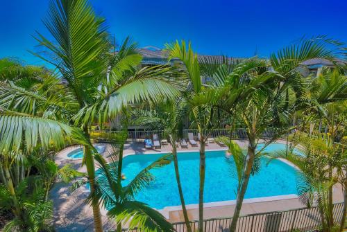 a view of the pool from the balcony of a resort at Bila Vista Kirra Beachside Apartments in Gold Coast