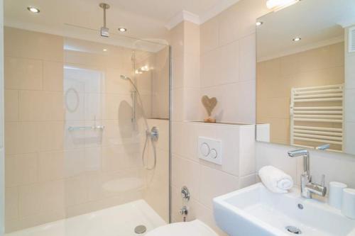 a bathroom with a shower and a sink and a toilet at Sylter Residenz, App 56 in Westerland