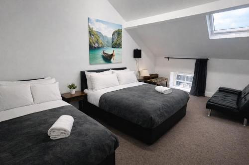 a hotel room with two beds and a window at BEST DEAL - Kings Hotel in Blackburn
