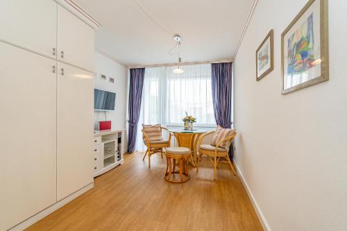 a kitchen and dining room with a table and chairs at Wiking, App 003 in Westerland