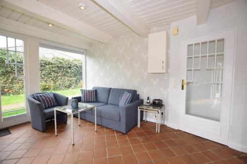 a living room with a couch and a table at Brönswai 5B in Westerland