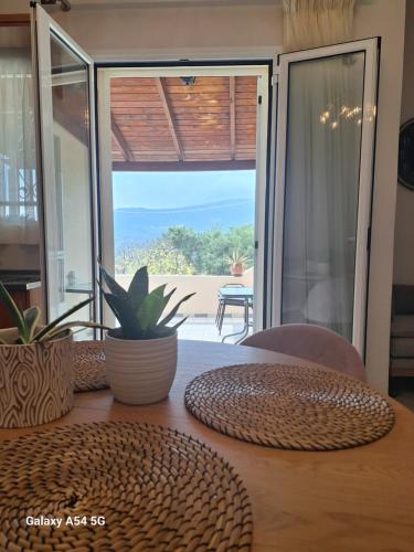 a room with a table with a view of the ocean at Kerkis View House in Karlovasi
