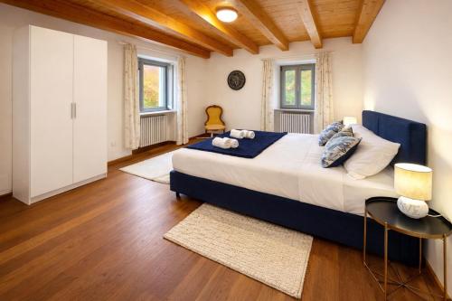 a large bedroom with a large bed and wooden ceilings at Aurisina heart apartment in Aurisina