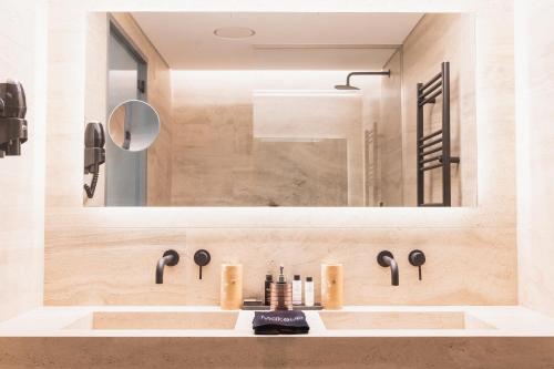 a bathroom with a sink and a mirror at Megara Hotel in Megara