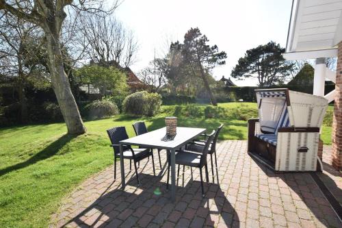 a table and chairs on a brick patio at Brönswai 5A in Westerland