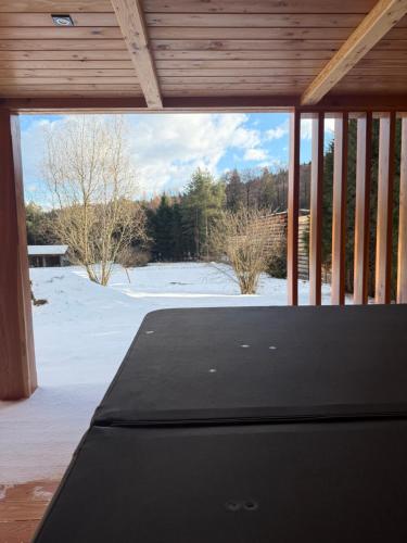 a screened in porch with a view of the snow at Leśna Przystań in Sidzina