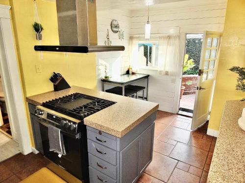 a kitchen with a stove and a counter top at Eastside Garden Hideaway For 4 Perfect Location for World Cup Attendees in Long Beach