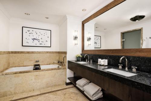 a bathroom with two sinks and a large mirror at Four Seasons Resort Vail in Vail