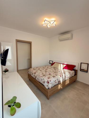 a bedroom with a bed in a white room at Casa Alpea in Villadossola