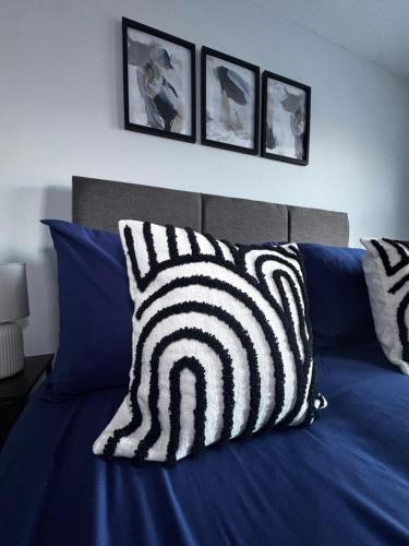 a bed with black and white pillows on it at Oakleigh Way, Carlisle - 2 Bedroom, sleeps 4, Fully furnished in Carlisle