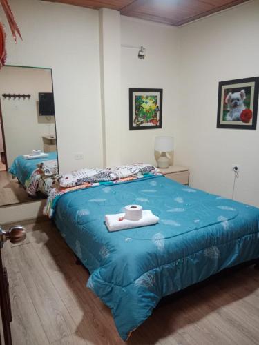 a bedroom with a bed with a towel on it at Habitación familiar Maoservi in Soacha