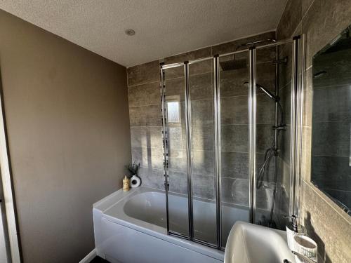 a bathroom with a shower and a white tub at Oakleigh Way, Carlisle - 2 Bedroom, sleeps 4, Fully furnished in Carlisle