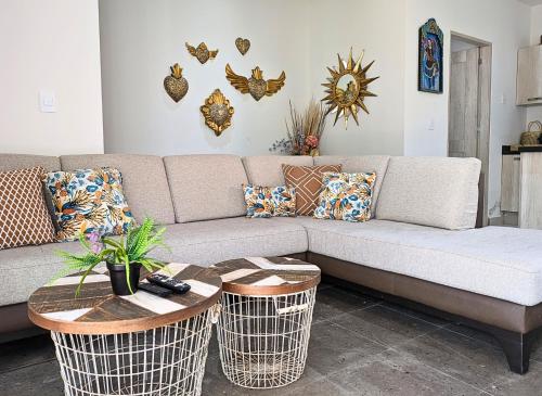 a living room with a couch and two tables at Casa Kora by Avelia in San Miguel de Allende
