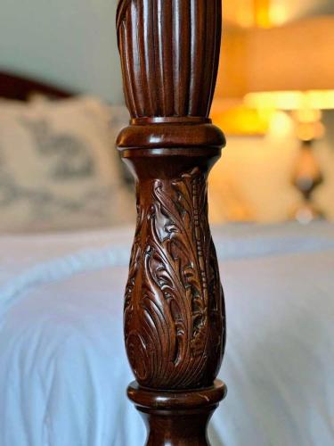 a wooden post on top of a bed at Bluebell Room in Oswego