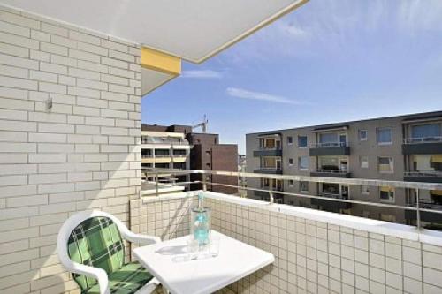 a white table and chairs on a balcony at Eydum, App 45 in Westerland