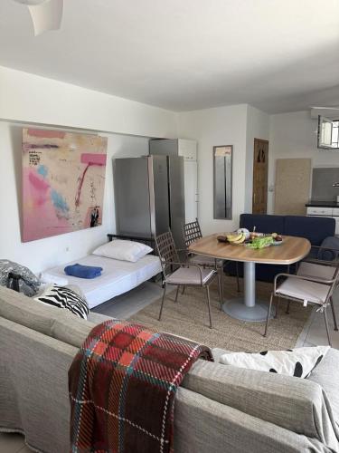 a living room with a couch and a table at ART BLUE Residence - Pool Access Apartment in Aghia Marina