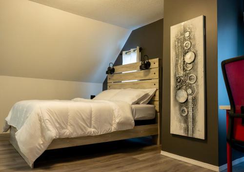 a bedroom with a bed and a picture on the wall at Cozy Home in Downtown Winnipeg in Winnipeg