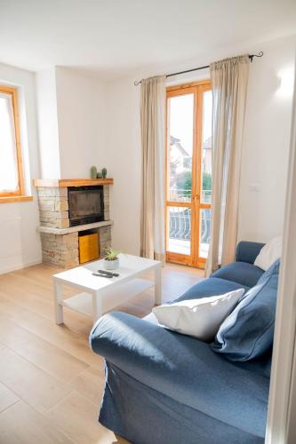 a living room with a blue couch and a table at Casa Simona in Dervio