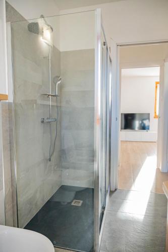 a shower with a glass door in a bathroom at Casa Simona in Dervio